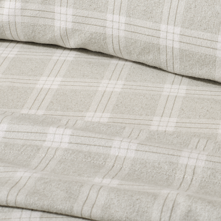 Close-up of gray fabric with a subtle plaid pattern