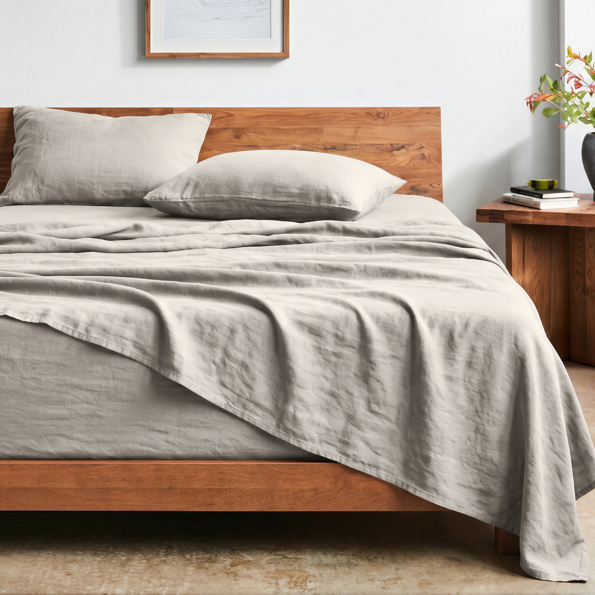 Bed with washed sheets and wooden headboard in a bedroom setting