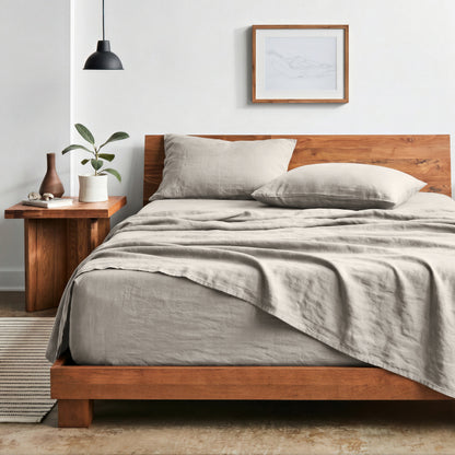 Bedroom with sheet set on a wooden bed frame and side table