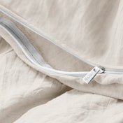 Close-up of a duvet cover with a zipper, featuring the brand Bare Home
