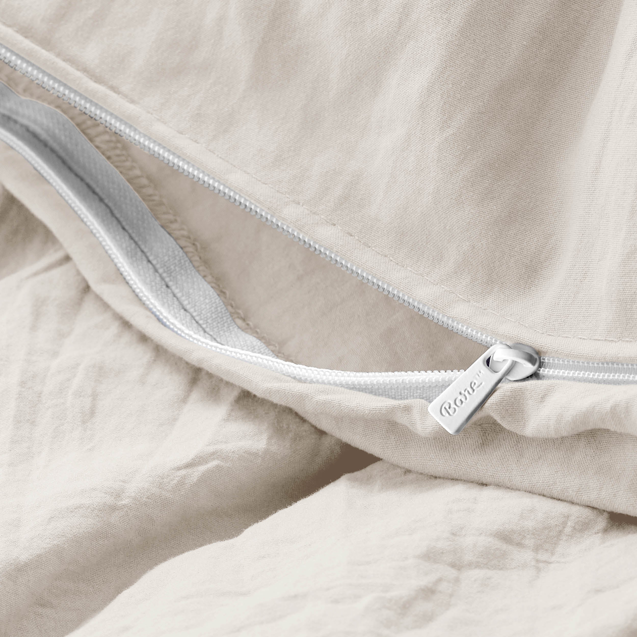Close-up of a duvet cover with a zipper, featuring the brand Bare Home