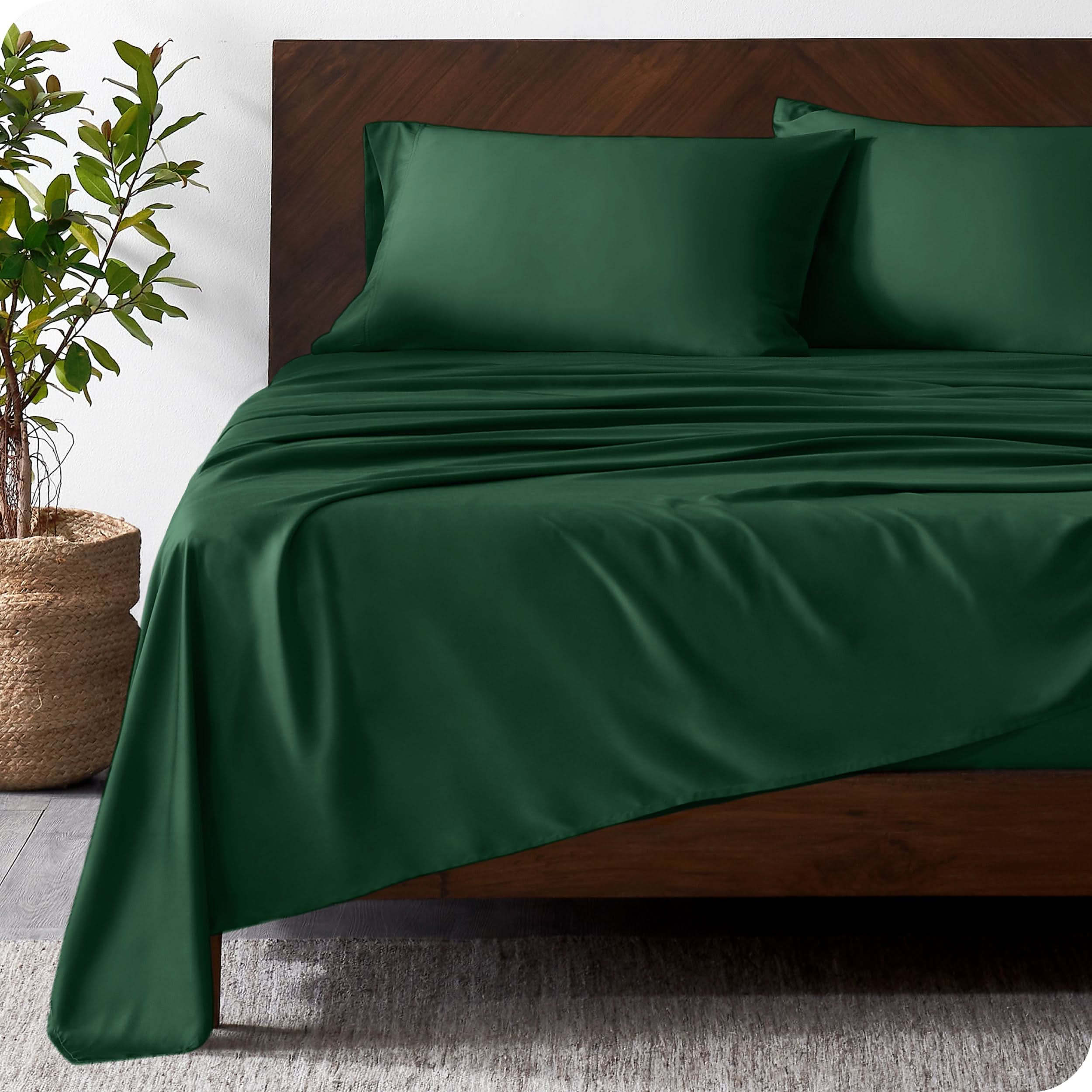 Wooded bed frame with bamboo sheets on the bed