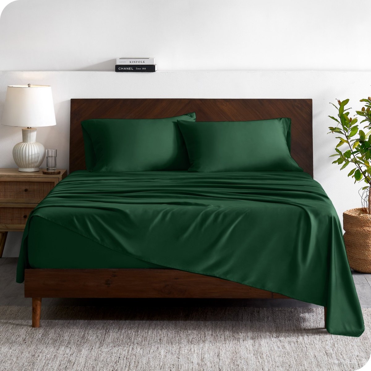A contemporary bed with a sheet set and a wooden headboard.