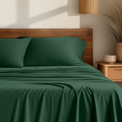 Bamboo sheets on a bed with a wooden headboard
