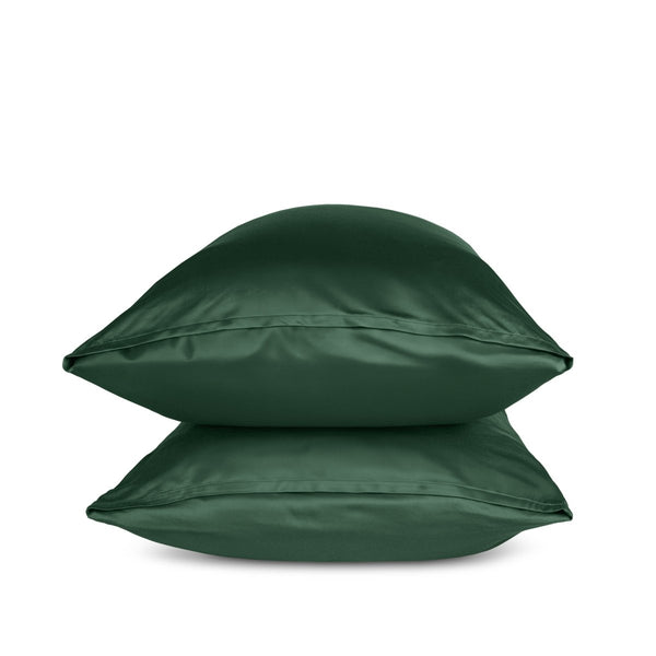 Two green pillows stacked on a white background