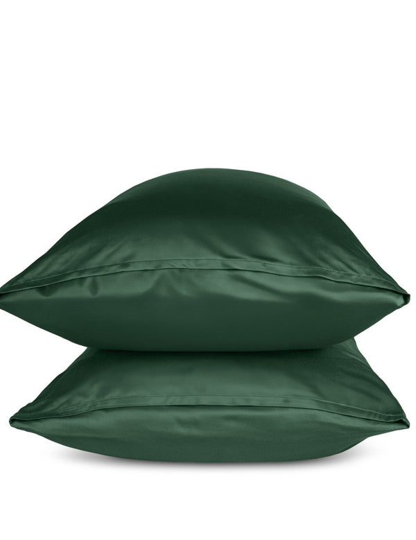 Two green pillows stacked on a white background