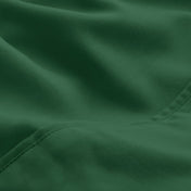 A close-up of microfiber fabric with soft folds and a visible stitched seam.