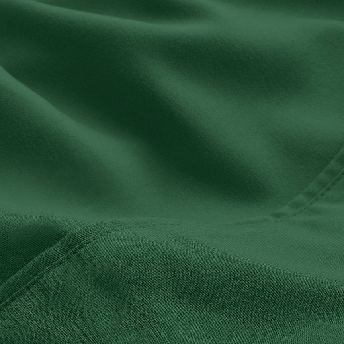 A close-up of microfiber fabric with soft folds and a visible stitched seam.