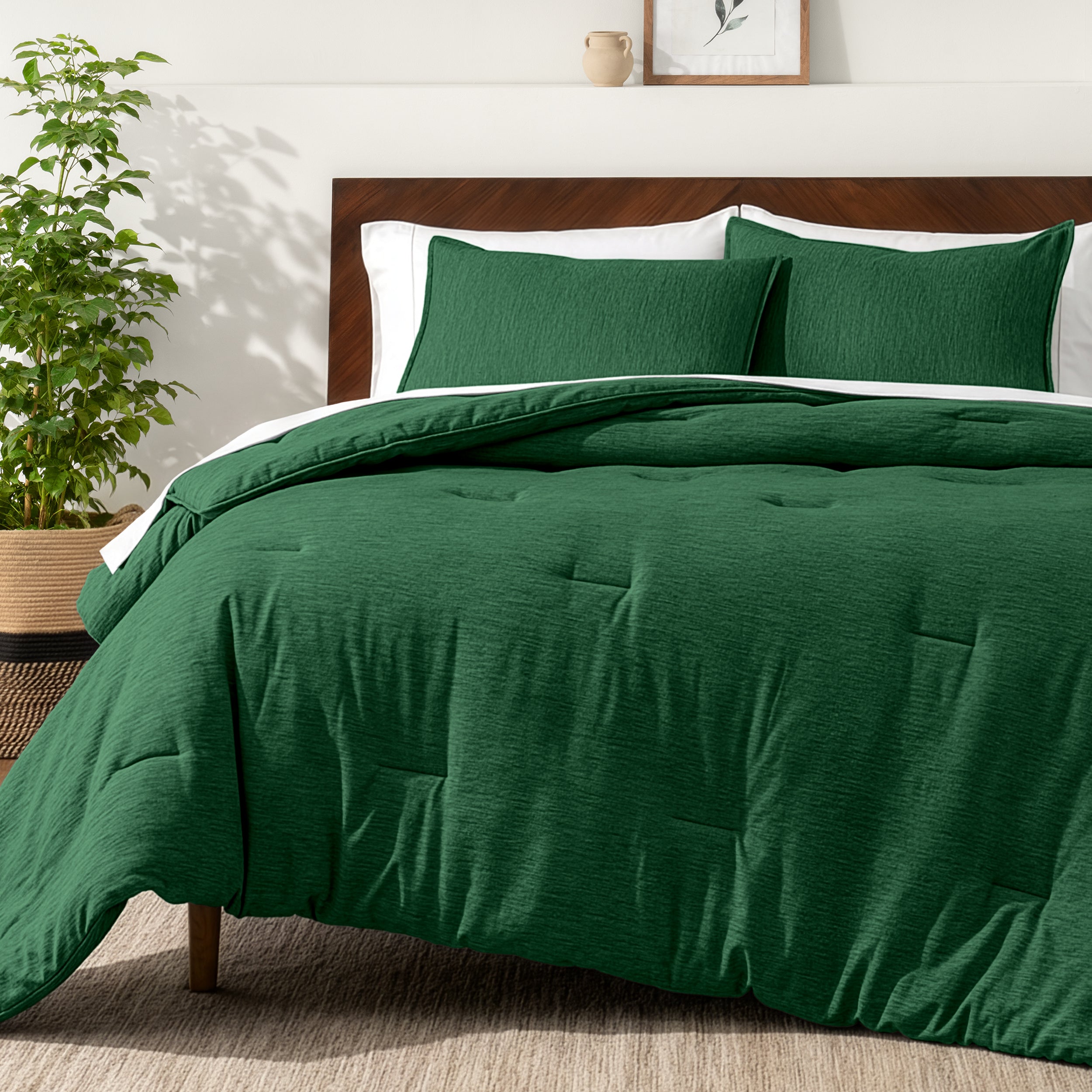 Bedding set on a bed in a bedroom with a side table and lamp.