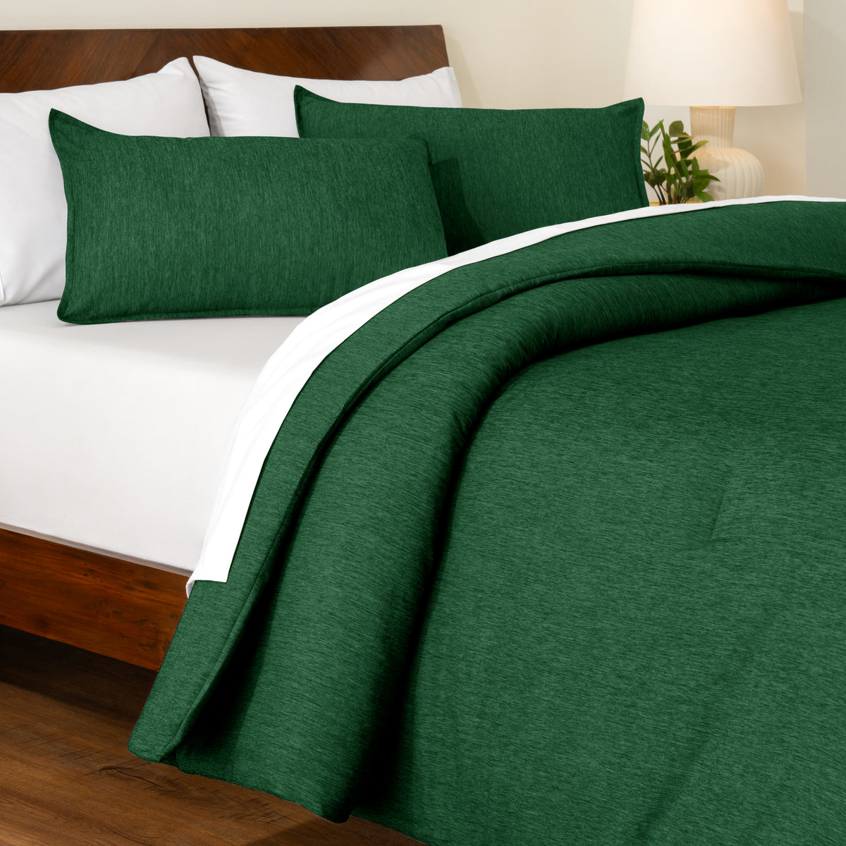 Track stitch comforter on a bed with white pillows and a wooden headboard.