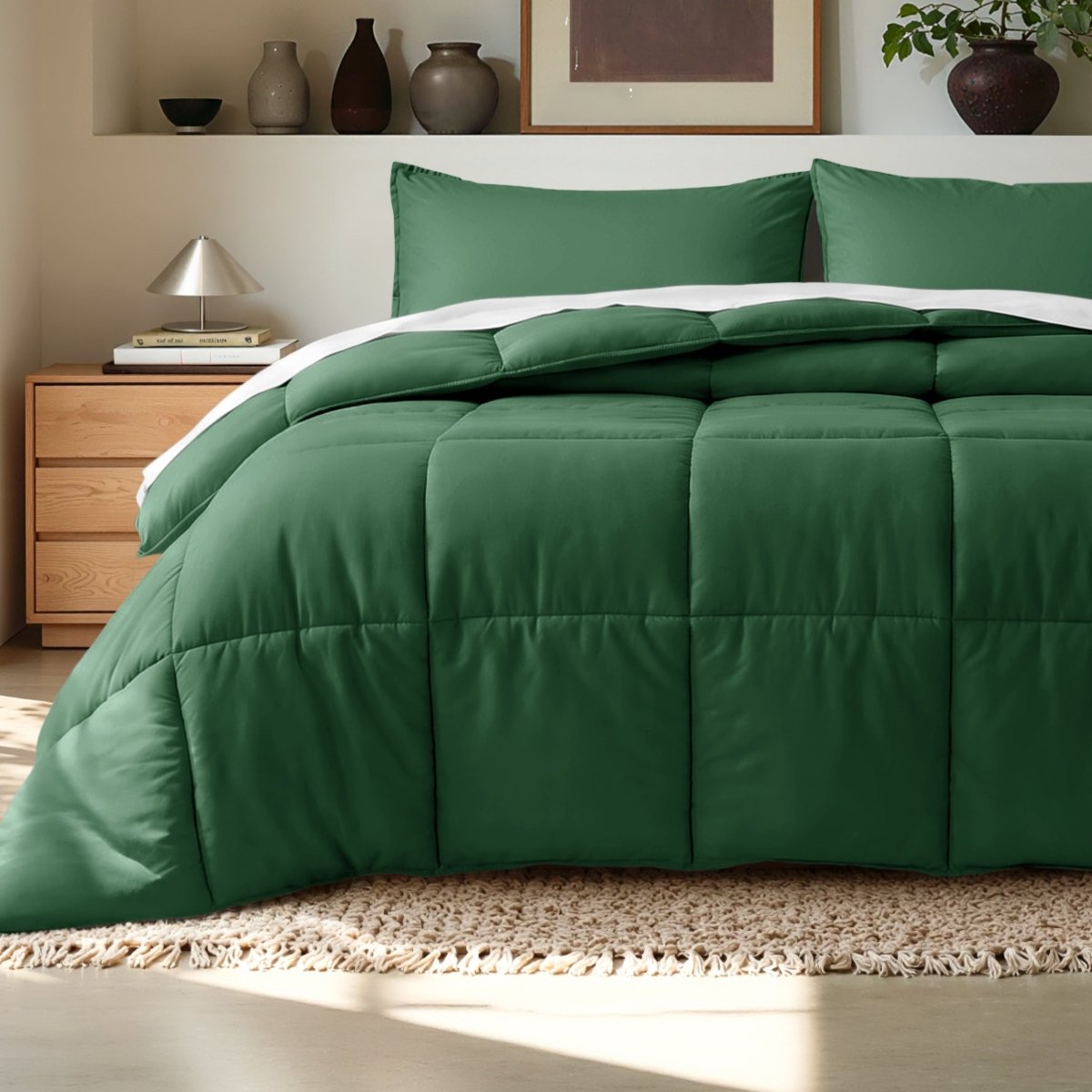 Comforter on a bed in a bedroom setting with a wooden nightstand and decorative items.