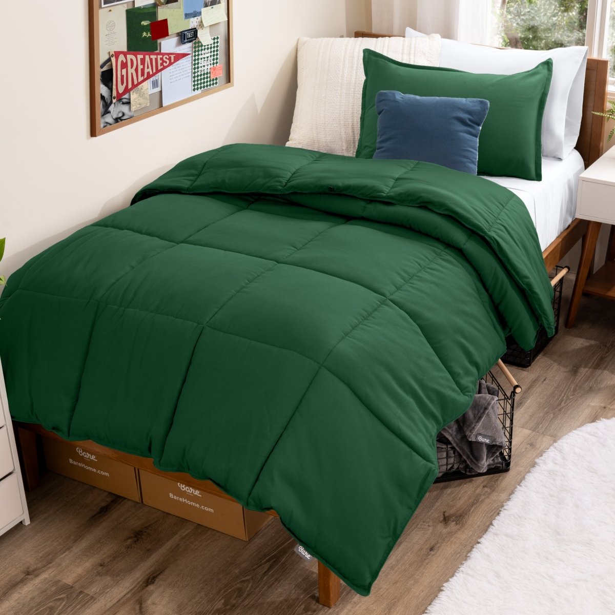 Bed with comforter and pillows in a dorm room
