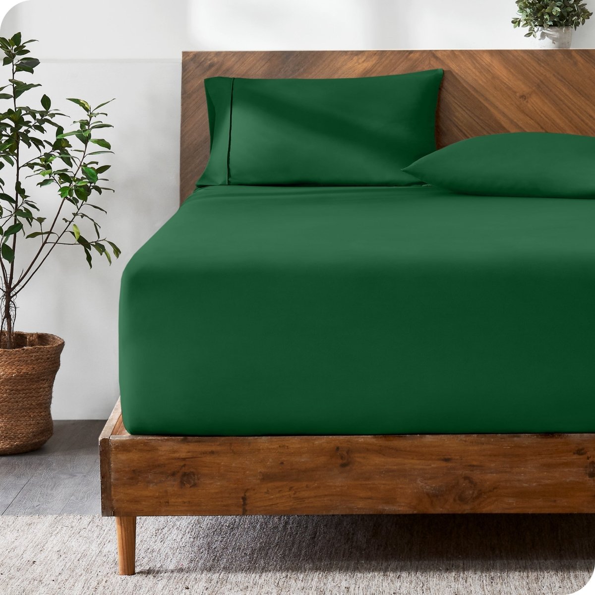 Wooden bed with ultra soft bedding in a minimalistic room.