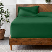 Wooden bed with ultra soft bedding in a minimalistic room.