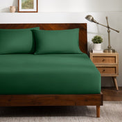 A bed dressed in a fitted sheet and two matching pillowcases.
