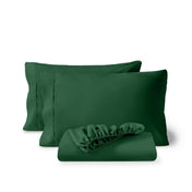 Pillowcases and a matching fitted sheet folded in front, shown on a plain white background.