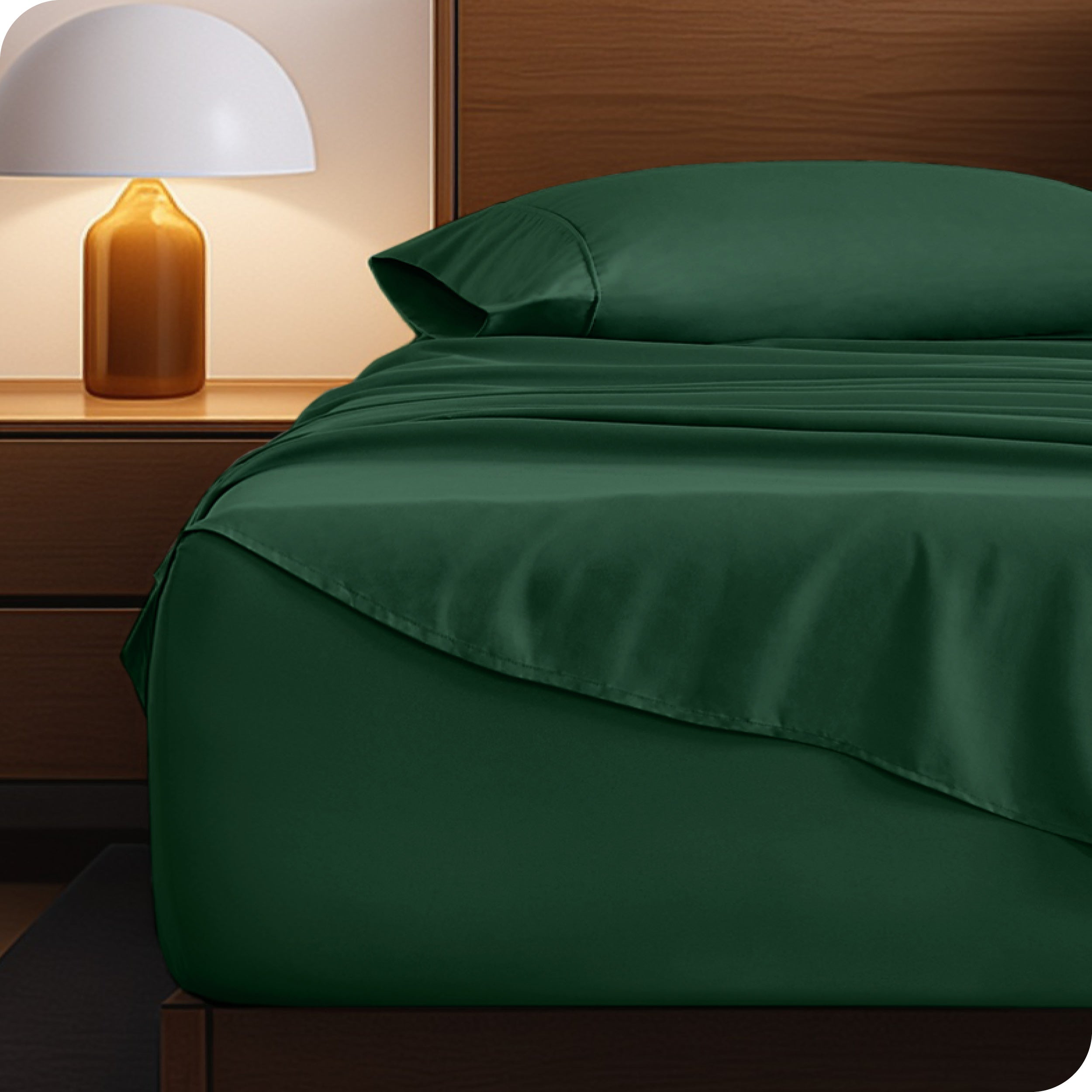 Microfiber bed sheets on a neatly made bed with a wooden headboard and nightstand.
