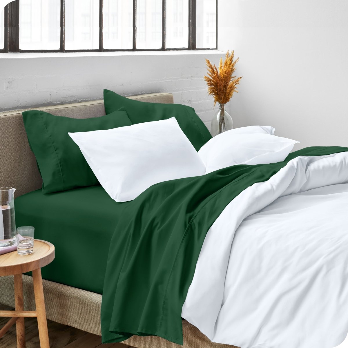 A side view of a bed made with microfiber sheets and a white duvet cover
