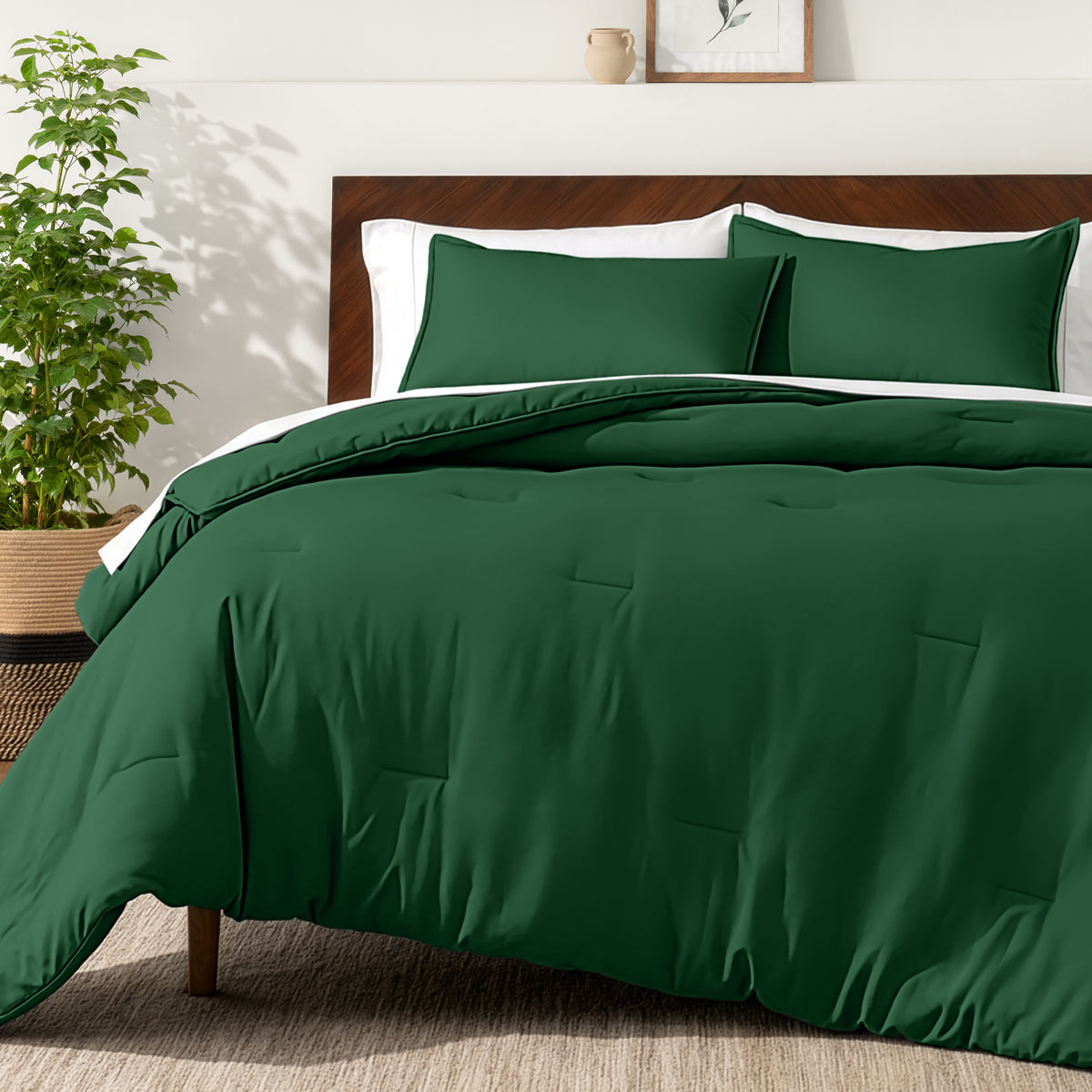 Bedding set on a bed in a bedroom with a side table and lamp.