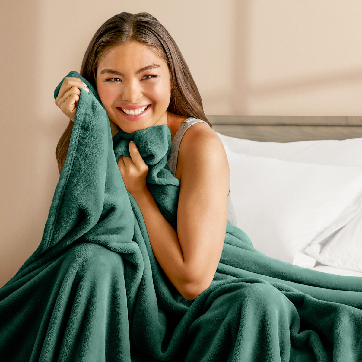 A woman cuddling with a microplush blanket