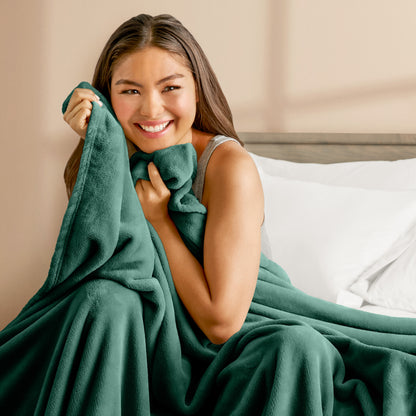 A woman cuddling with a microplush blanket