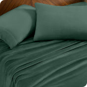 A sheet set and matching pillowcases on a bed.