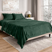 Neatly made bed in a well-lit bedroom.