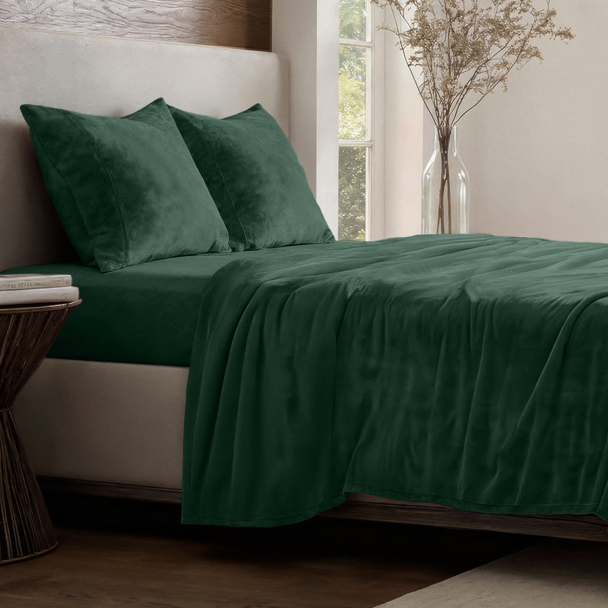 Neatly made bed in a well-lit bedroom.