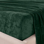 Close-up of the corner of a bed made with microplush sheets