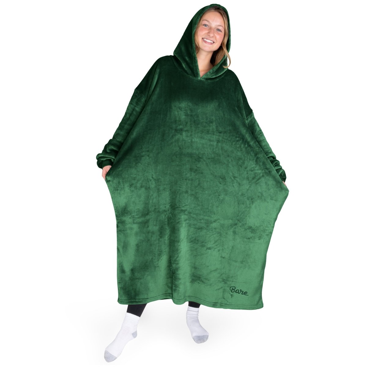 An adult with long microplush wearable blanket on