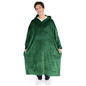 An adult is standing while wearing a long microplush wearable blanket