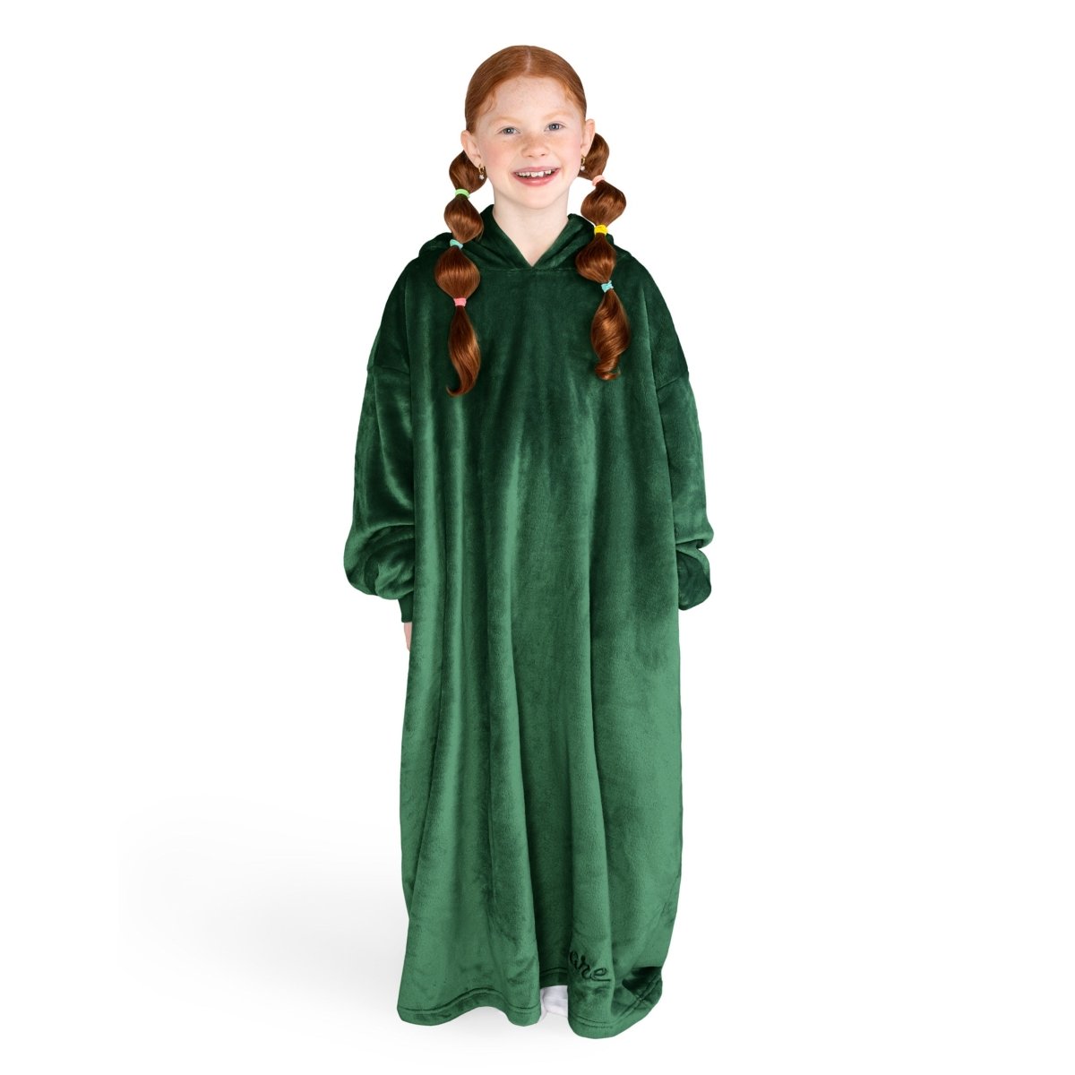 A girl is standing while wearing a long microplush wearable blanket