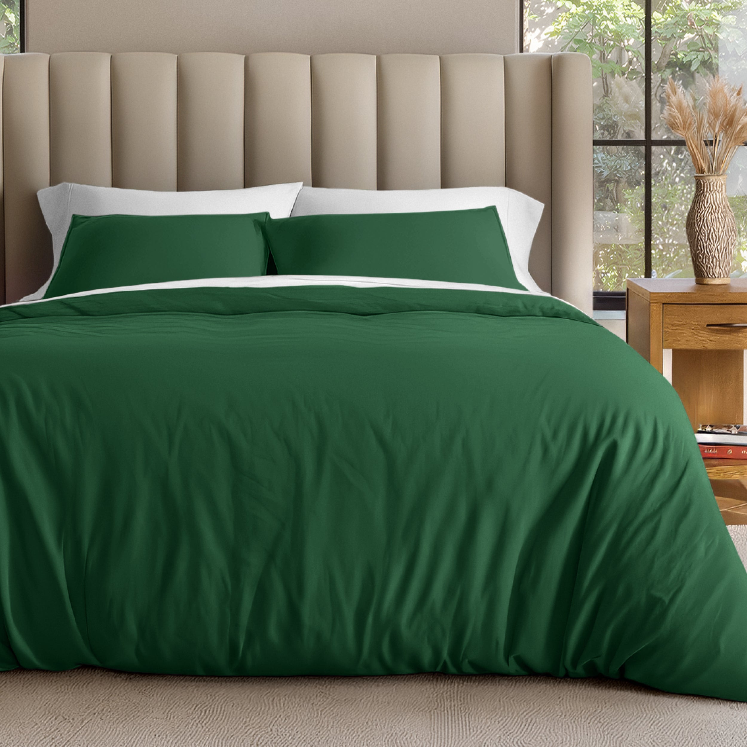 Neatly made bed with organic jersey bedding and pillow shams in a bedroom setting.