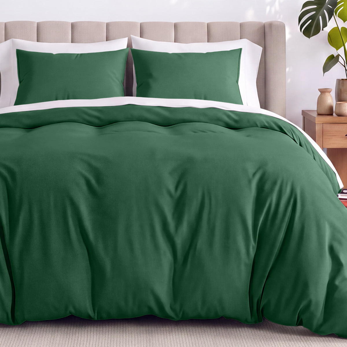 Neatly made bed with organic jersey bedding and pillow shams in a bedroom setting.