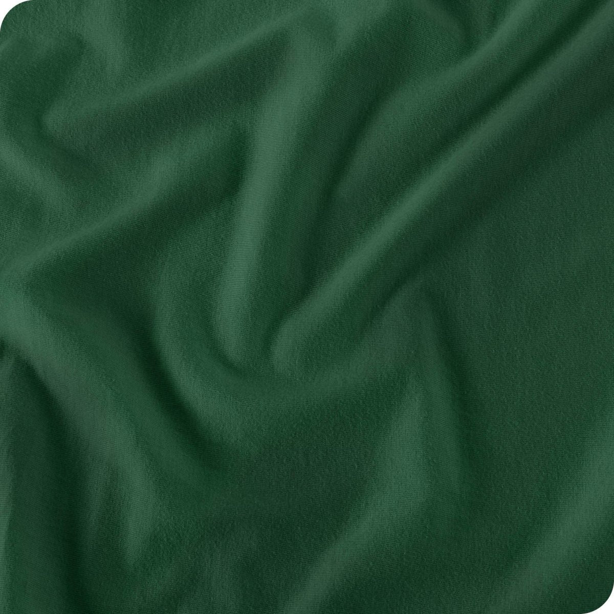 A forest green fitted sheet folded