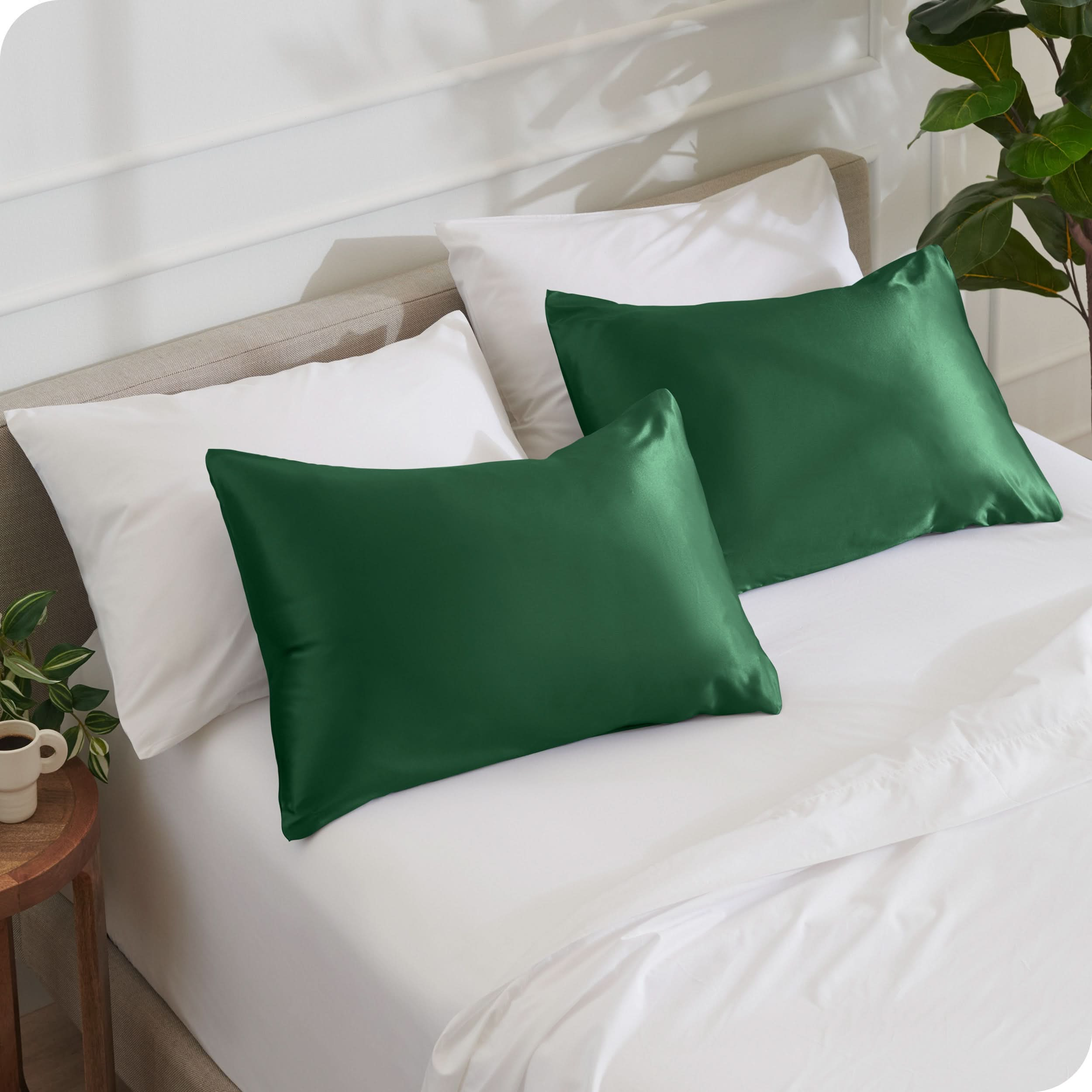 2 satin pillowcases on pillows set on a bed