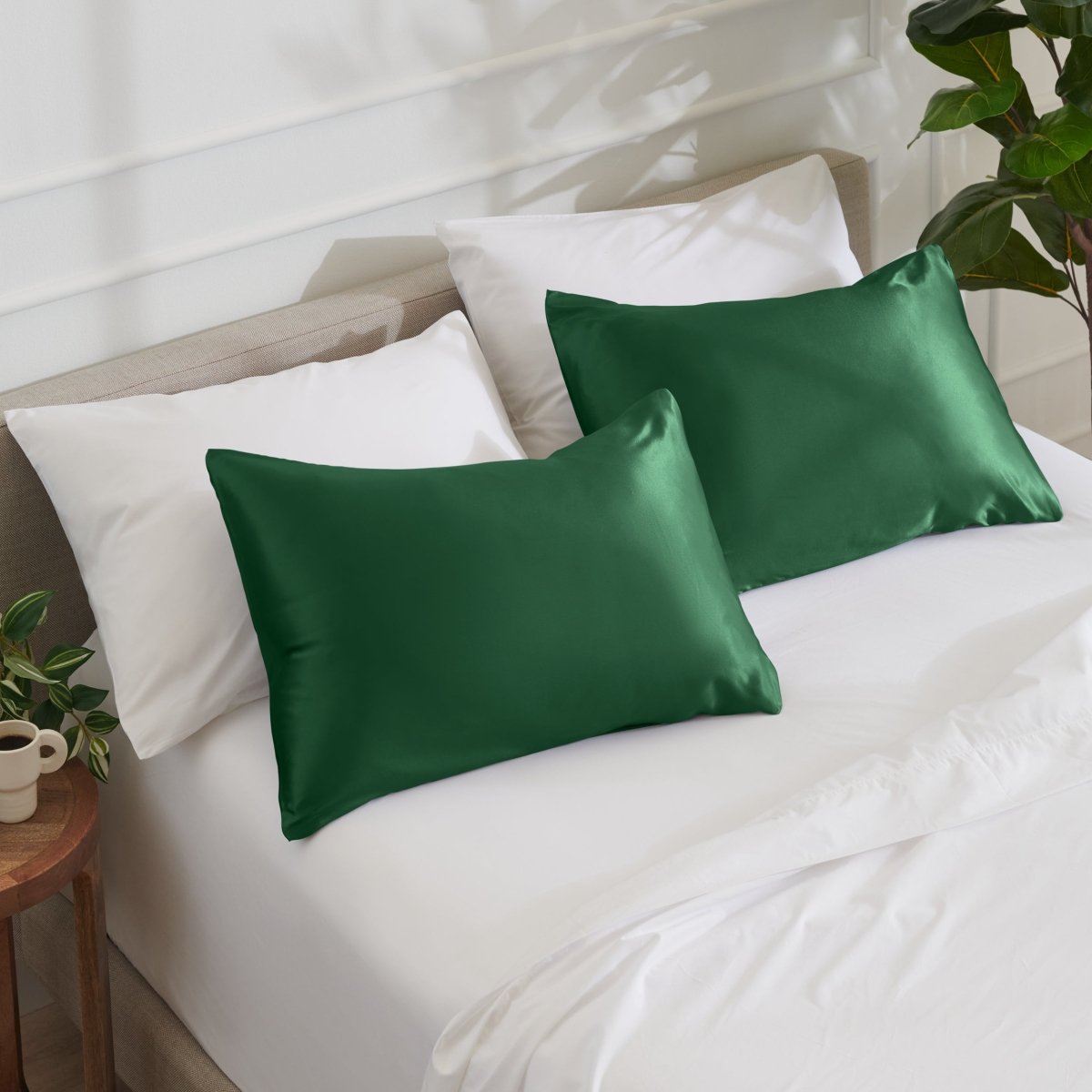 Satin pillowcases on a bed with white bedding