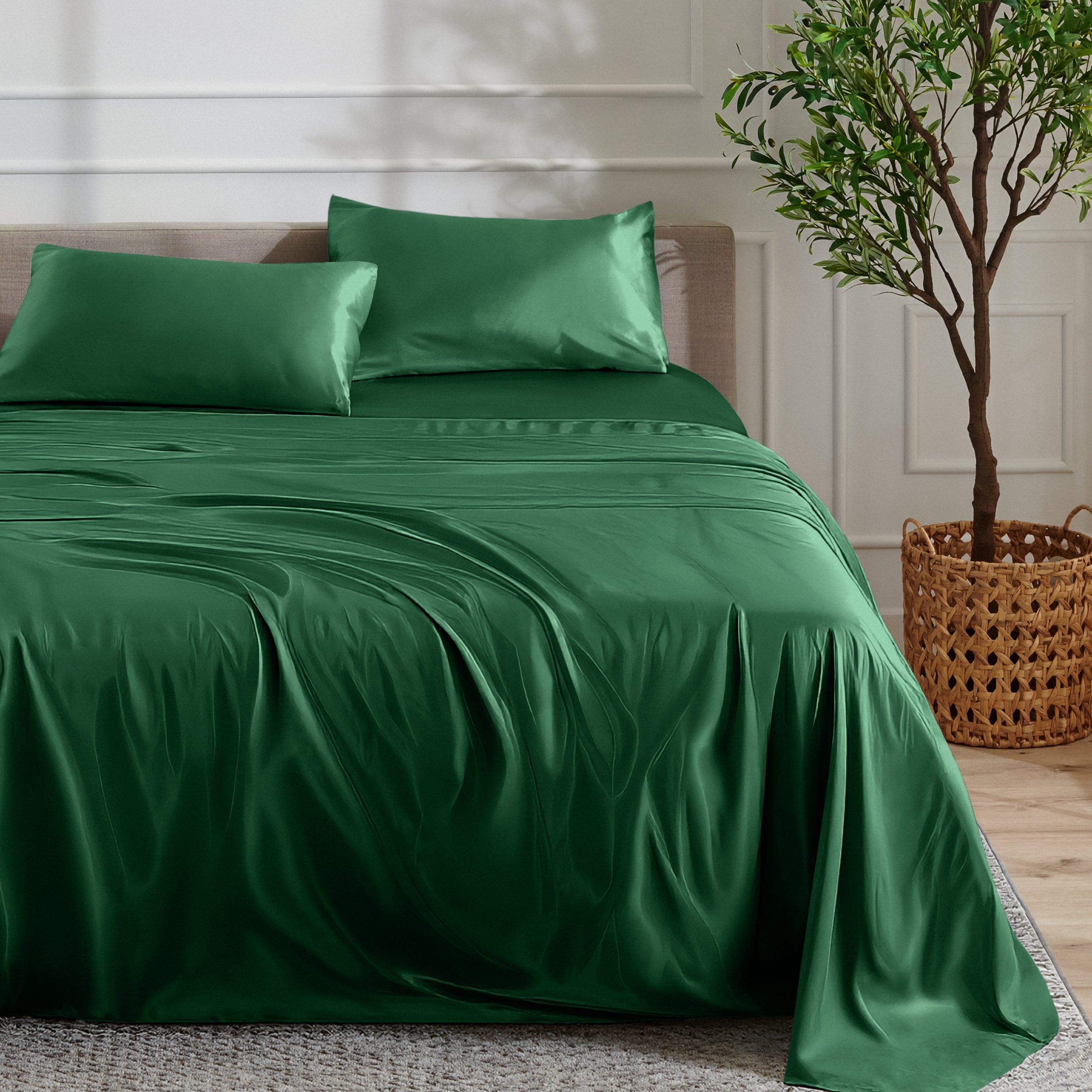 Satin sheet set on a bed with a plant and basket in the background