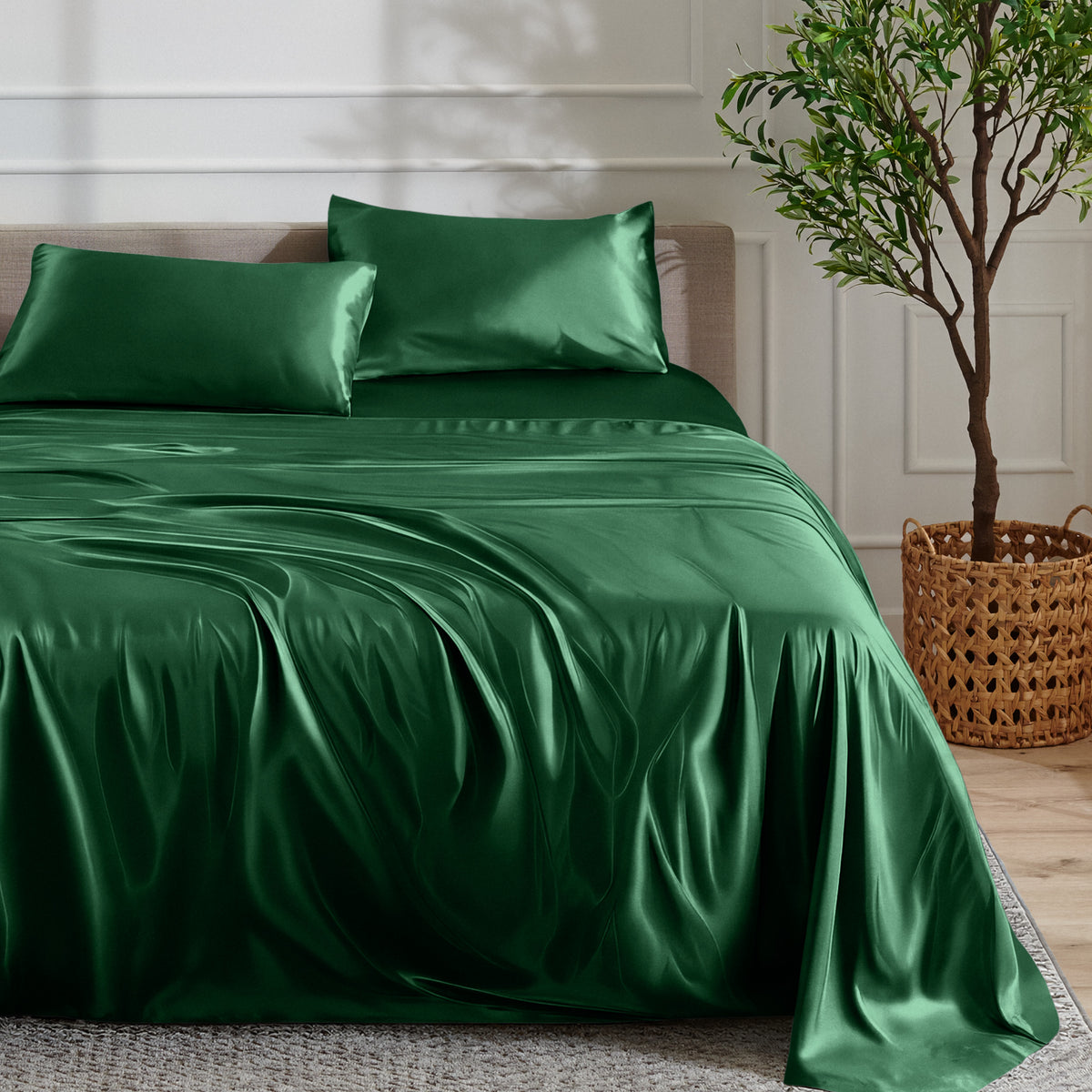 Satin sheet set on a bed with a plant and basket in the background