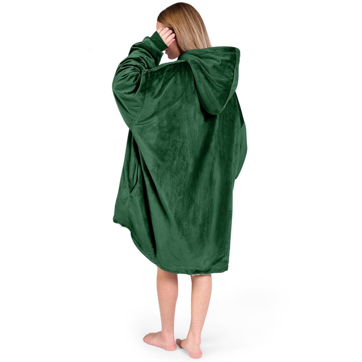 An adult with a sherpa wearable blanket on