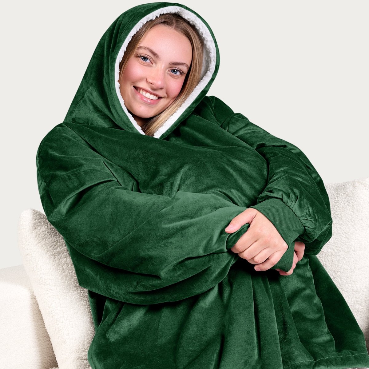 An adult with a sherpa wearable blanket on