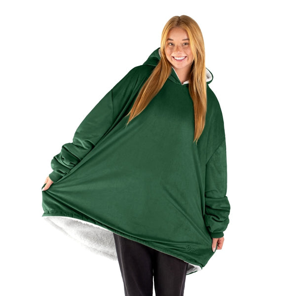 An adult with a sherpa wearable blanket on