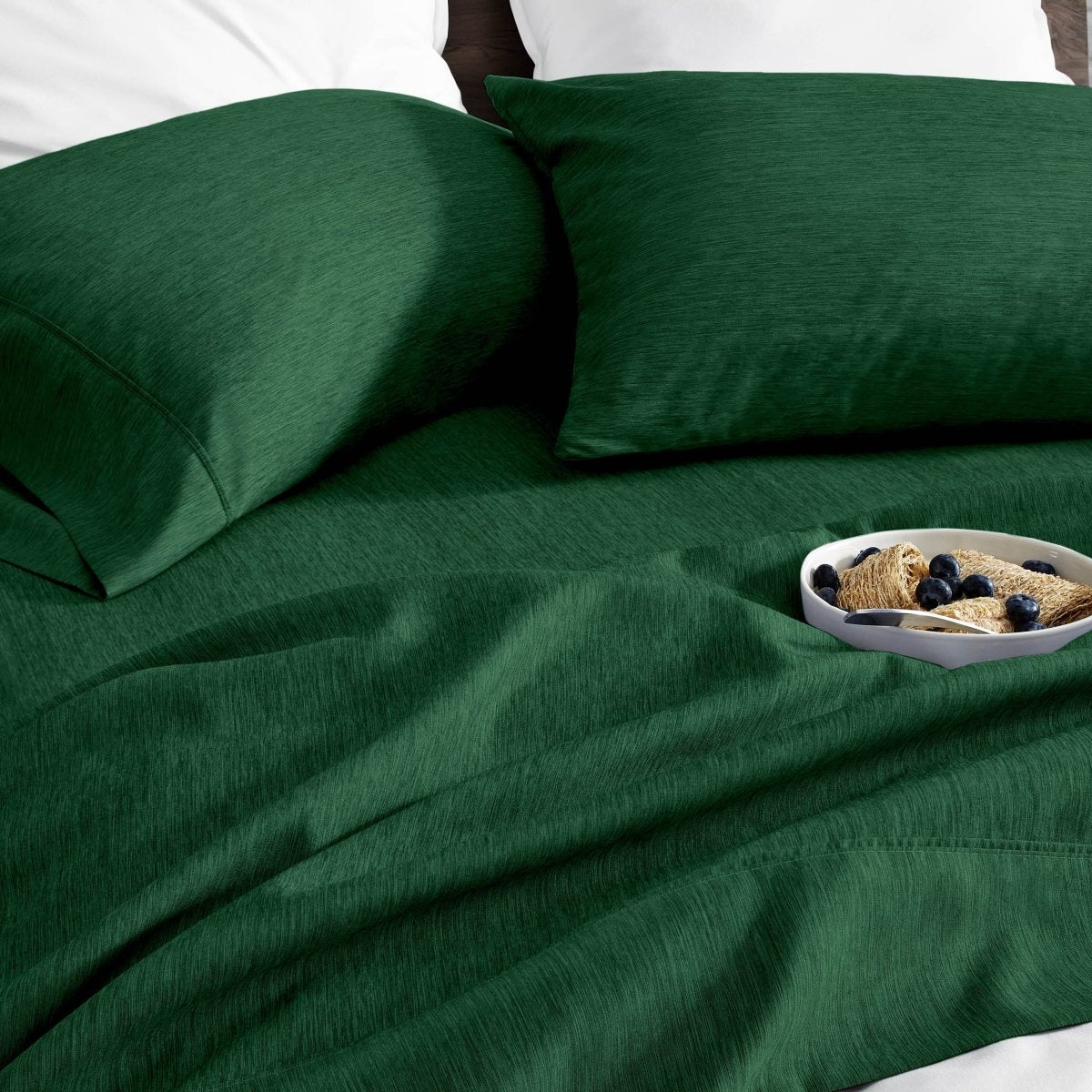 Ultra soft sheet set with a bowl of food on a bed