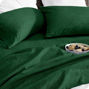 Bedding set on a bed with a bowl of cereal on a white background