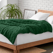 A weighted blanket draped over a bed