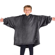 A boy wearing a blanket made of microplush, showcasing comfort and warmth.