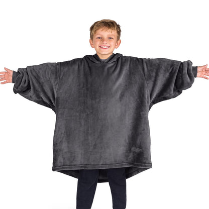 A boy wearing a blanket made of microplush, showcasing comfort and warmth.