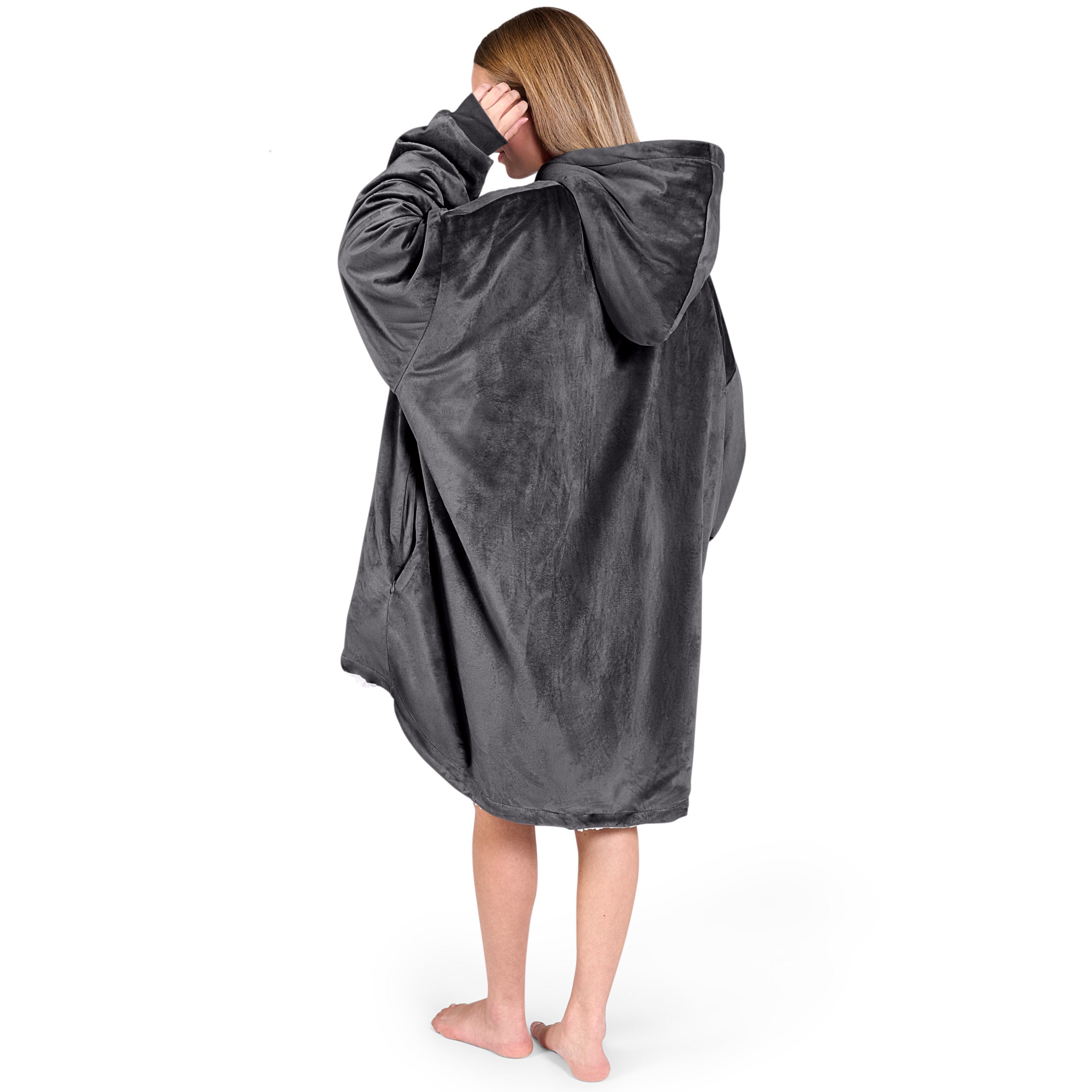 An adult with a hooded wearable blanket on