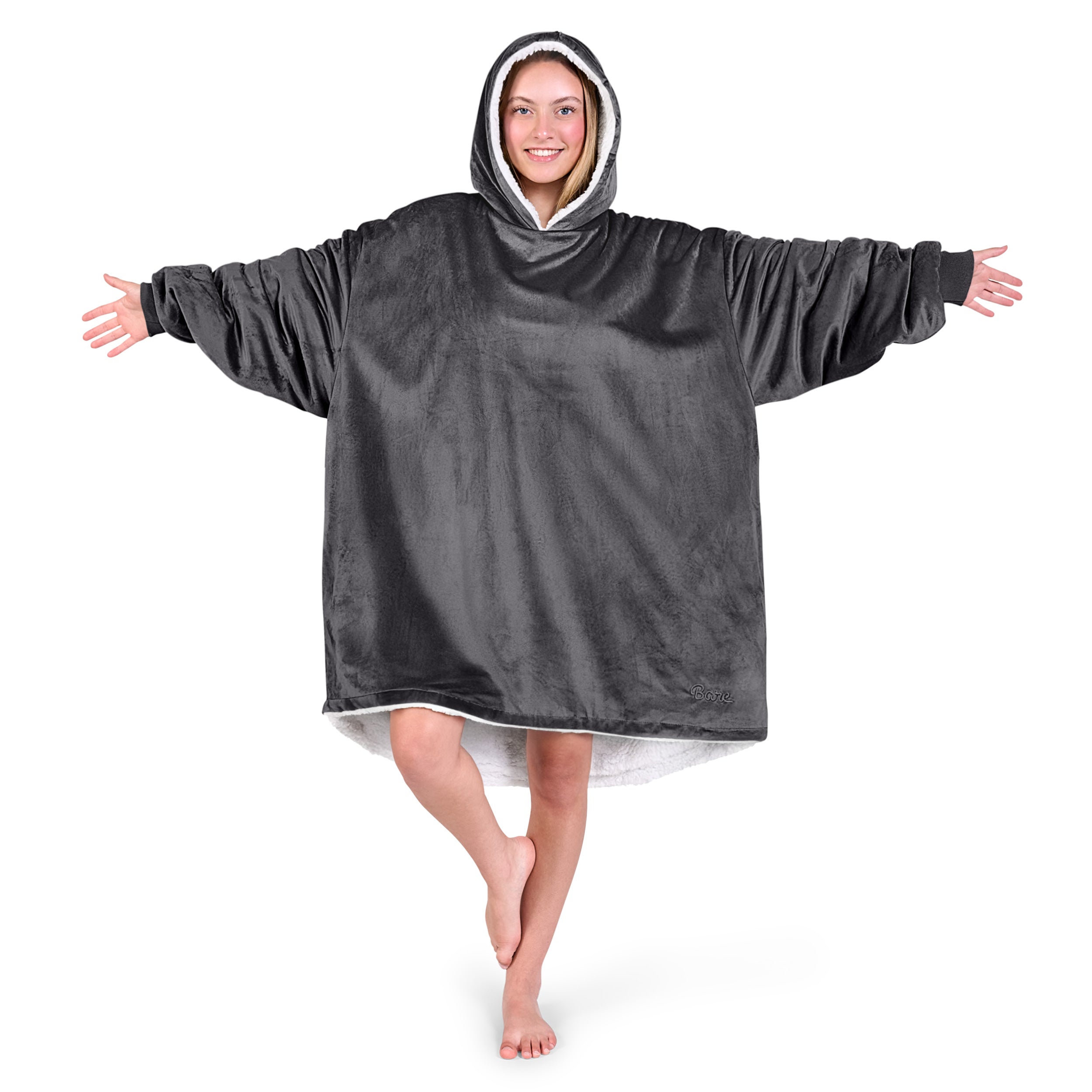An adult with a sherpa wearable blanket on