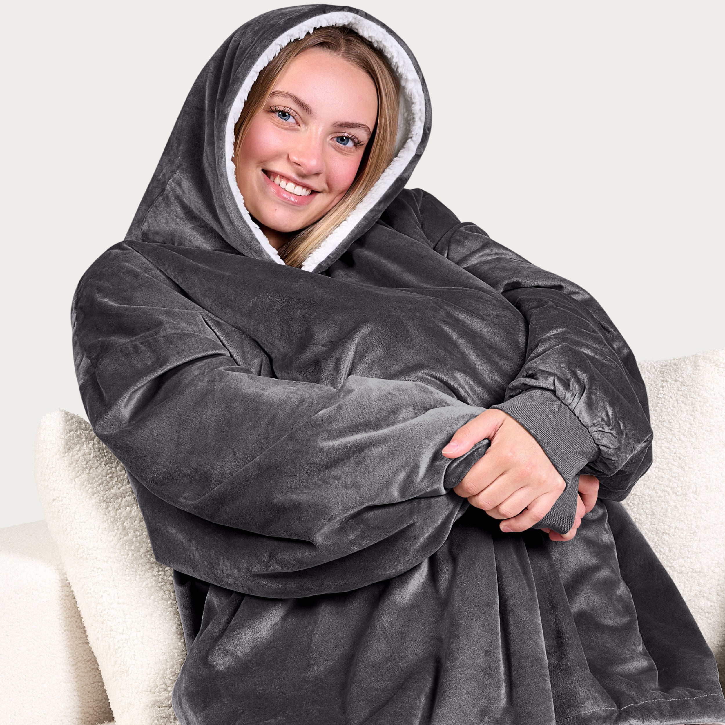 An adult with a sherpa wearable blanket on